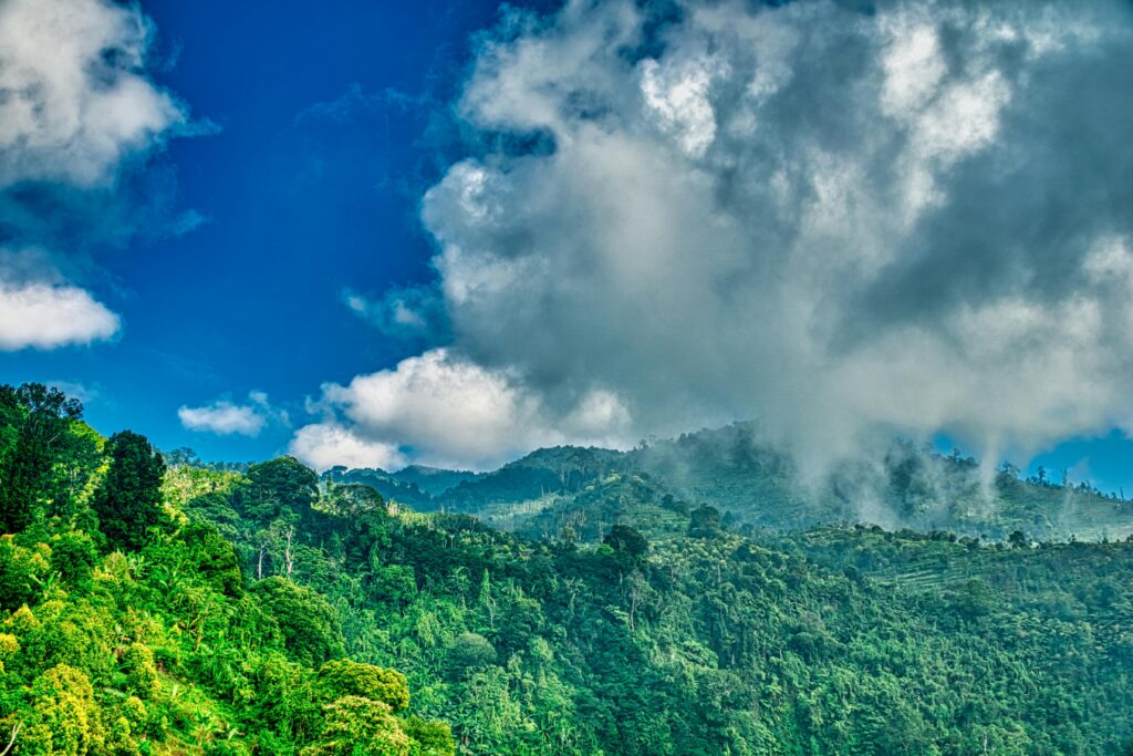 Explore the lush green hills and dynamic cloud formations of Banten, Indonesia's tropical paradise.